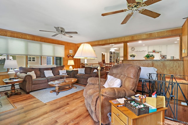 3914 N Richmond Rd, Johnsburg, IL 60051 - living room featuring ceiling fan, wood finished floors, wooden walls, and baseboard heating