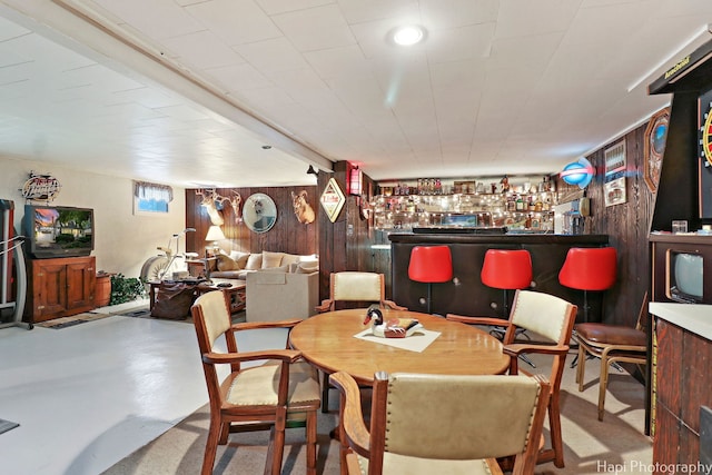 3914 N Richmond Rd, Johnsburg, IL 60051 - dining space with wood walls, finished concrete flooring, and a dry bar