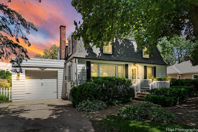 3914 N Richmond Rd, Johnsburg, IL 60051 - view of front of home with a garage, driveway, roof with shingles, and a chimney