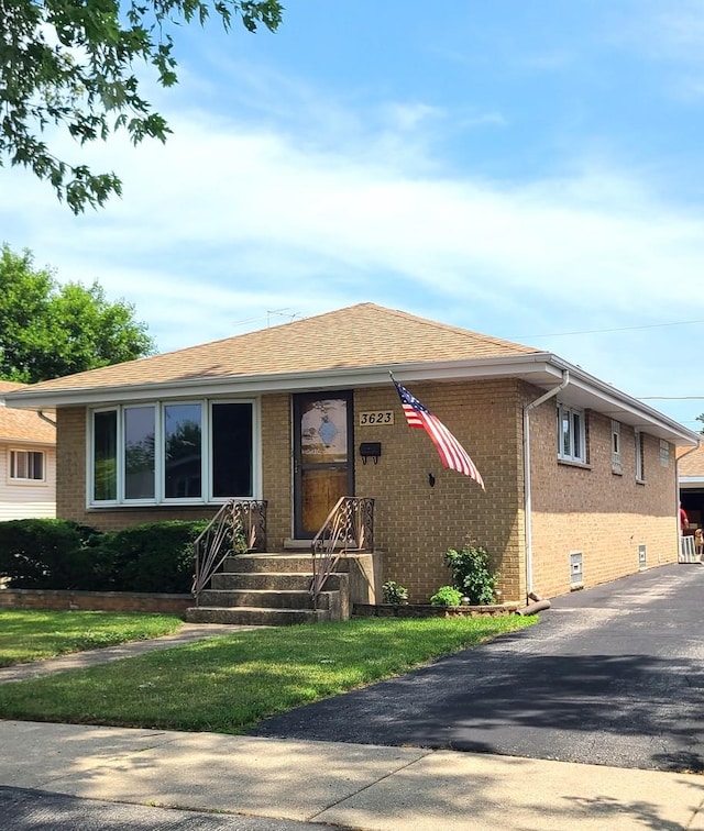 3623 Hawthorne St, Franklin Park, IL 60131 - view of front of home featuring brick siding, a front yard, and a shingled roof