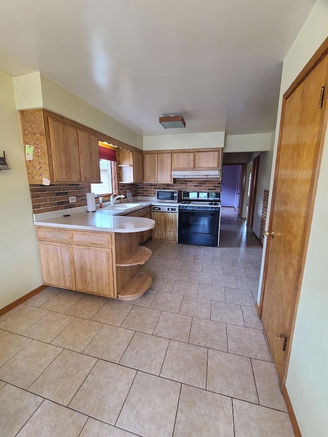 3623 Hawthorne St, Franklin Park, IL 60131 - kitchen with range with gas cooktop, a peninsula, tasteful backsplash, light countertops, and light tile patterned floors