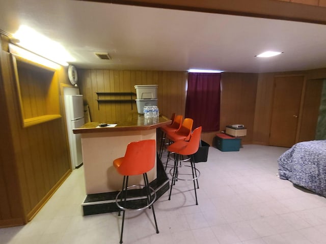 3623 Hawthorne St, Franklin Park, IL 60131 - indoor dry bar featuring wood walls, freestanding refrigerator, and light flooring