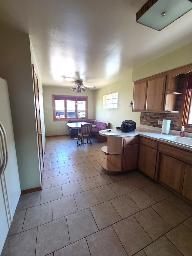 3623 Hawthorne St, Franklin Park, IL 60131 - kitchen featuring ceiling fan, a peninsula, tile patterned floors, open shelves, and light countertops