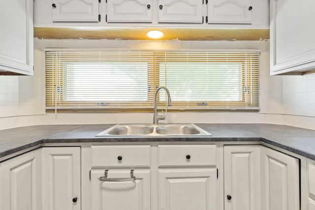 8716 S Merrill Ave, Chicago, IL 60617 - kitchen with dark countertops, white cabinetry, and backsplash