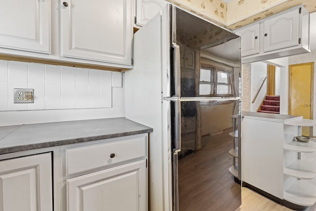 8716 S Merrill Ave, Chicago, IL 60617 - kitchen with open shelves, white cabinetry, light wood-type flooring, tasteful backsplash, and dark countertops