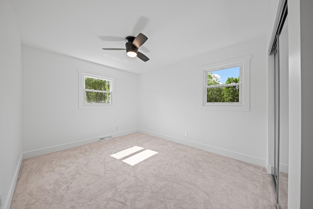 214 Somerset Ct, New Lenox, IL 60451 - unfurnished bedroom with multiple windows, carpet, a closet, and ceiling fan