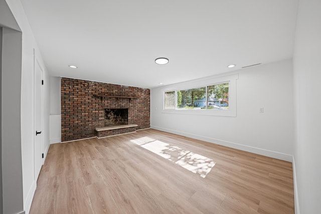 214 Somerset Ct, New Lenox, IL 60451 - unfurnished living room featuring a brick fireplace, light wood-style flooring, and recessed lighting