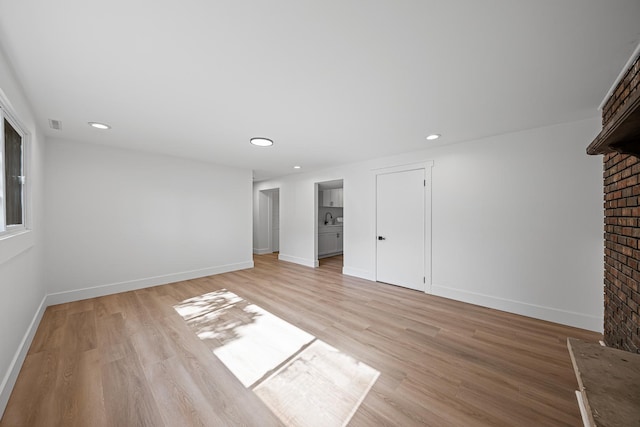 214 Somerset Ct, New Lenox, IL 60451 - unfurnished living room featuring light wood-type flooring, recessed lighting, and a brick fireplace