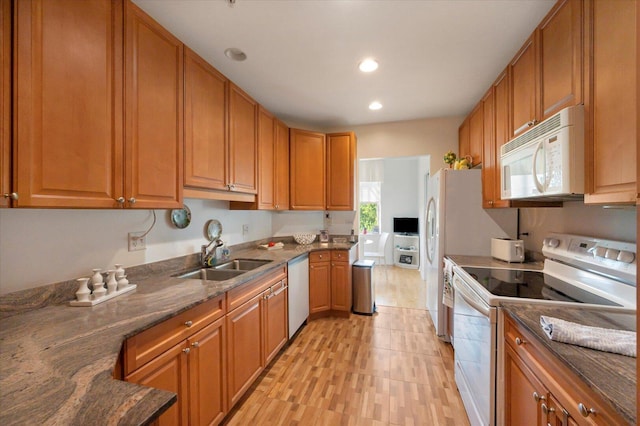 1700 Riverwoods Dr Unit 520, Melrose Park, IL 60160 - kitchen featuring white appliances, brown cabinetry, dark stone countertops, recessed lighting, and light wood-style flooring
