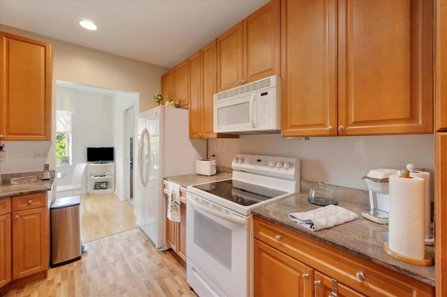 1700 Riverwoods Dr Unit 520, Melrose Park, IL 60160 - kitchen with white appliances, light wood-style flooring, stone countertops, recessed lighting, and brown cabinets