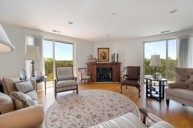 1700 Riverwoods Dr Unit 520, Melrose Park, IL 60160 - living room featuring healthy amount of natural light, light wood-style flooring, a fireplace, and recessed lighting