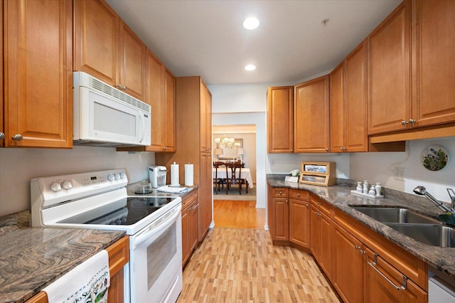 1700 Riverwoods Dr Unit 520, Melrose Park, IL 60160 - kitchen featuring white appliances, light wood-type flooring, recessed lighting, brown cabinets, and a chandelier