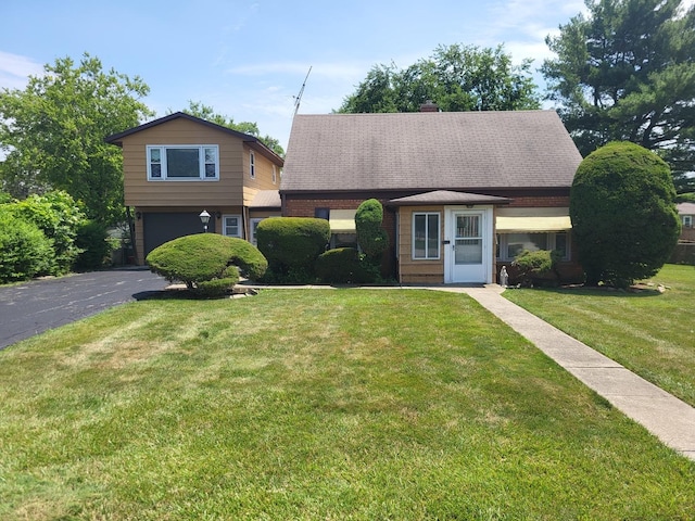 3021 N Prater Ave, Melrose Park, IL 60164 - view of front of property featuring an attached garage, a front yard, driveway, and a chimney