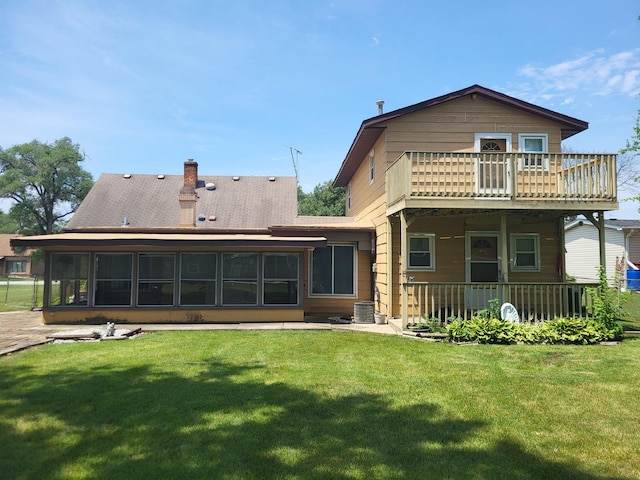 3021 N Prater Ave, Melrose Park, IL 60164 - back of house featuring a sunroom, a yard, and a balcony