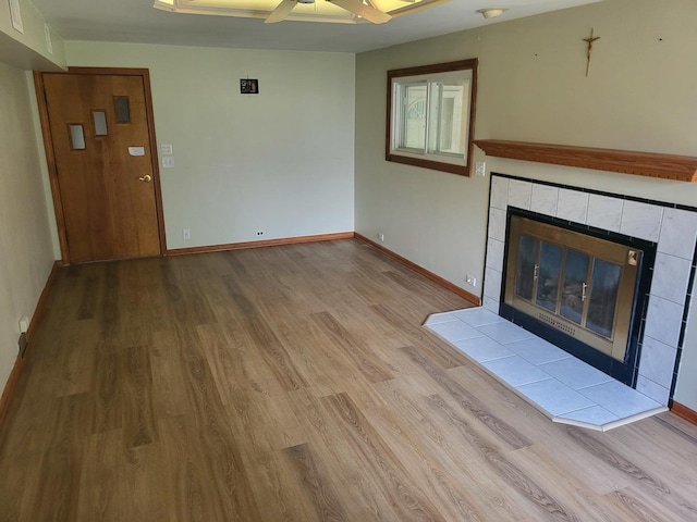 3021 N Prater Ave, Melrose Park, IL 60164 - unfurnished living room featuring wood finished floors, ceiling fan, and a tile fireplace
