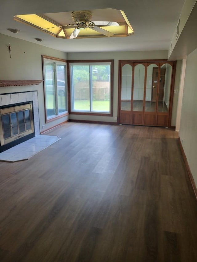 3021 N Prater Ave, Melrose Park, IL 60164 - unfurnished living room with a tile fireplace, dark wood-style flooring, and ceiling fan