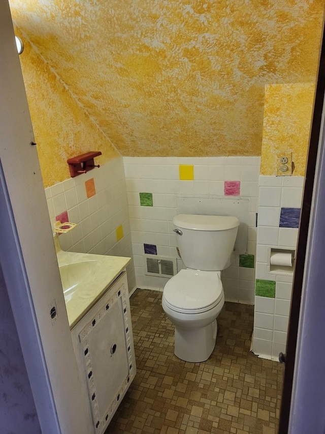 3021 N Prater Ave, Melrose Park, IL 60164 - bathroom with vanity, tile walls, and a wainscoted wall