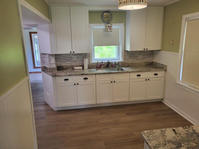 3021 N Prater Ave, Melrose Park, IL 60164 - kitchen with a wainscoted wall, white cabinets, light stone countertops, and dark wood finished floors
