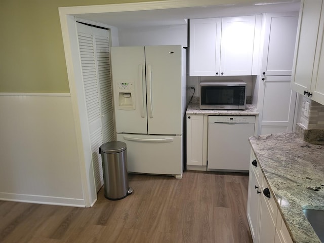 3021 N Prater Ave, Melrose Park, IL 60164 - kitchen featuring white appliances, light wood-style flooring, white cabinetry, and light stone countertops