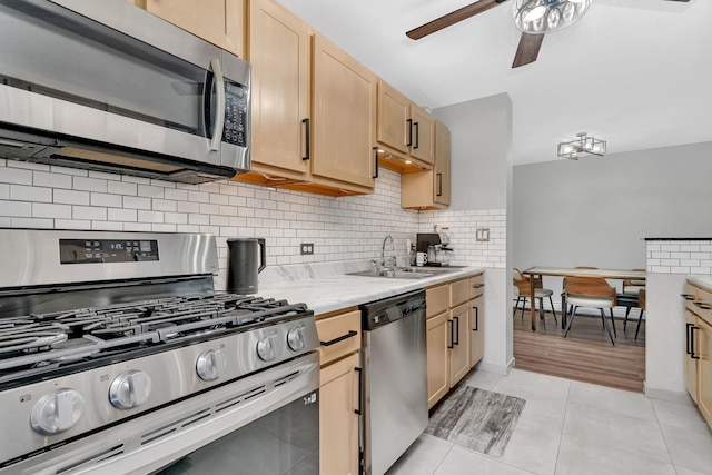 520 Burning Tree Ln Unit 306, Naperville, IL 60563 - kitchen featuring stainless steel appliances, ceiling fan, light countertops, decorative backsplash, and light brown cabinets