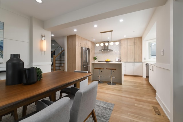 5309 Crain St, Skokie, IL 60077 - dining area featuring stairs, recessed lighting, and light wood-style floors