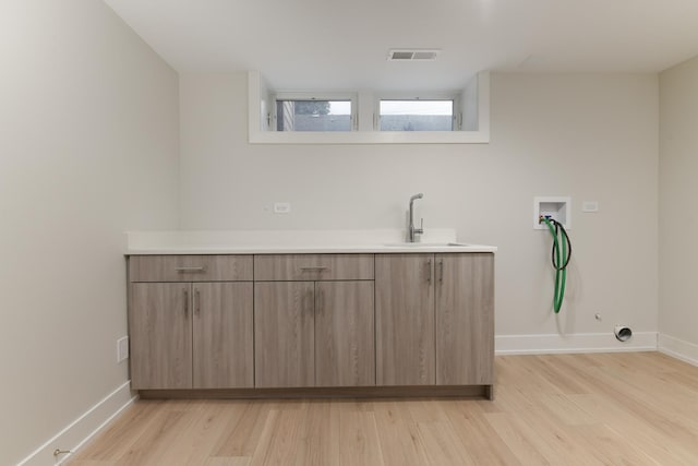 5309 Crain St, Skokie, IL 60077 - laundry area with washer hookup, light wood finished floors, and hookup for a gas dryer