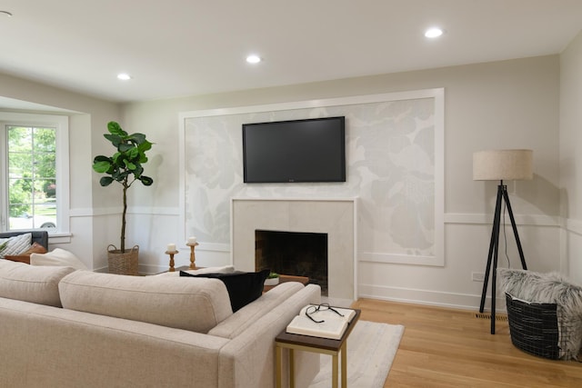 5309 Crain St, Skokie, IL 60077 - living area featuring light wood-style floors, recessed lighting, a premium fireplace, a wainscoted wall, and a decorative wall