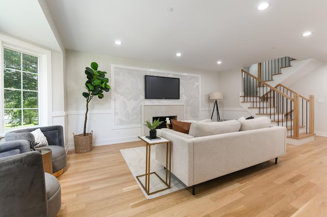 5309 Crain St, Skokie, IL 60077 - living room with light wood finished floors, stairs, a high end fireplace, and recessed lighting
