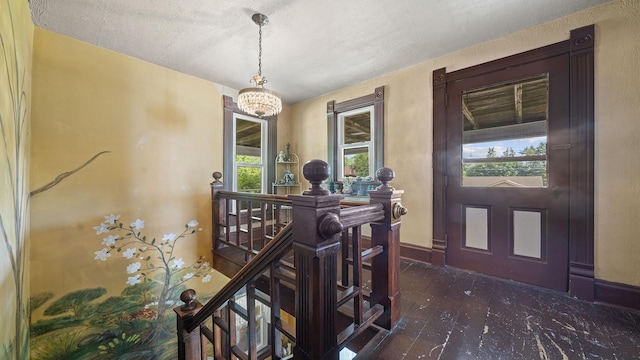 123 E 3rd St, Byron, IL 61010 - entryway with a chandelier, hardwood / wood-style floors, and a textured ceiling