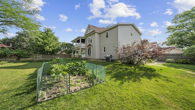 123 E 3rd St, Byron, IL 61010 - rear view of house featuring a fenced backyard and a garden