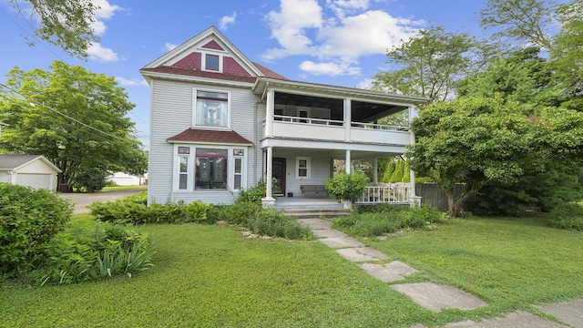 123 E 3rd St, Byron, IL 61010 - victorian home with a balcony, covered porch, and a front yard