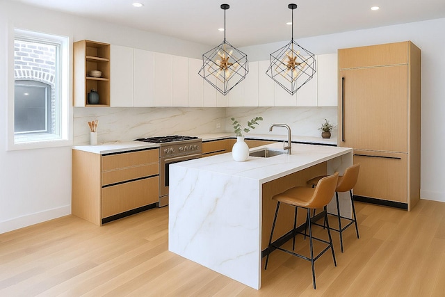1325 N Artesian Ave Unit 3, Chicago, IL 60622 - kitchen featuring high end appliances, light wood-style flooring, tasteful backsplash, modern cabinets, and recessed lighting