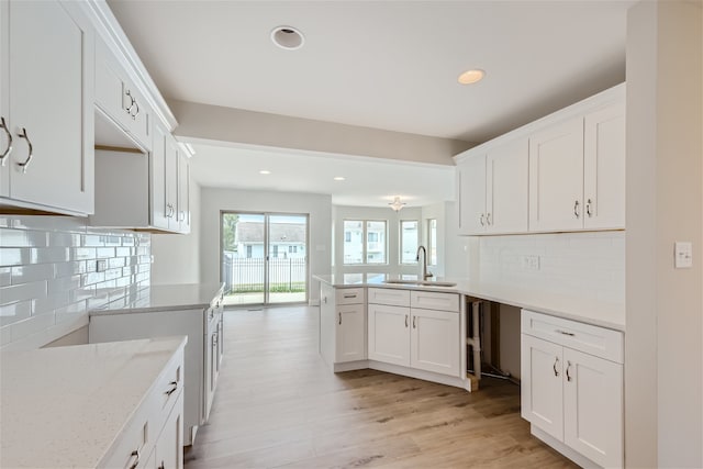 21210 Shannon Dr, Matteson, IL 60443 - kitchen with a peninsula, backsplash, light wood finished floors, white cabinetry, and recessed lighting