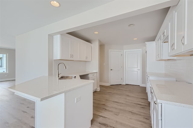 21210 Shannon Dr, Matteson, IL 60443 - kitchen featuring a peninsula, light wood-style flooring, white cabinets, light stone countertops, and recessed lighting