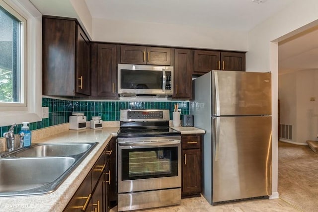 1441 Haverhill Dr Unit B, Wheaton, IL 60189 - kitchen with stainless steel appliances, dark brown cabinetry, light countertops, and backsplash