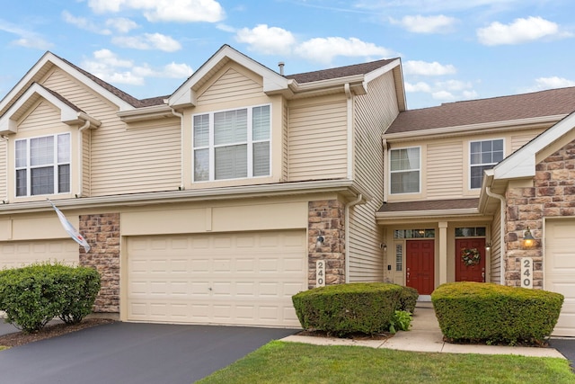 2406 Georgetown Cir, Aurora, IL 60503 - view of front of house with stone siding, a garage, driveway, and roof with shingles
