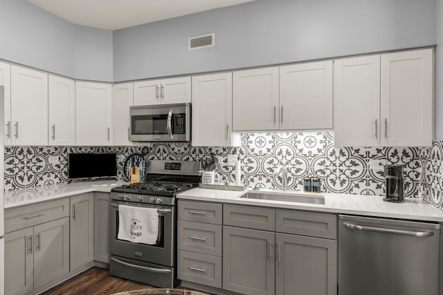 2406 Georgetown Cir, Aurora, IL 60503 - kitchen with appliances with stainless steel finishes, gray cabinets, light countertops, and decorative backsplash