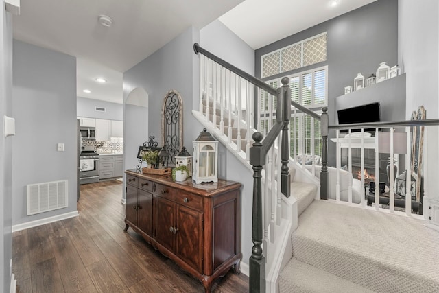 2406 Georgetown Cir, Aurora, IL 60503 - staircase with wood finished floors, arched walkways, and recessed lighting