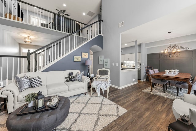2406 Georgetown Cir, Aurora, IL 60503 - living area featuring a high ceiling, a chandelier, dark wood-style floors, stairway, and ceiling fan