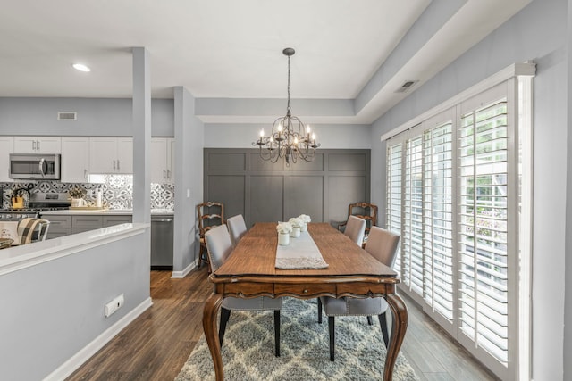 2406 Georgetown Cir, Aurora, IL 60503 - dining space with a chandelier and dark wood-type flooring