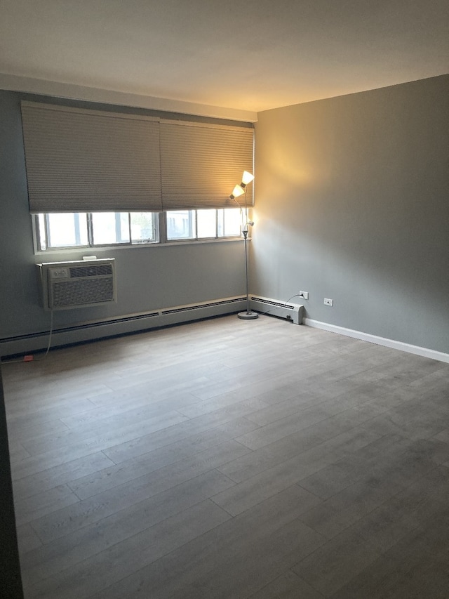 6300 N Sheridan Rd Unit 517, Chicago, IL 60660 - unfurnished room featuring baseboard heating, a wall unit AC, and wood finished floors