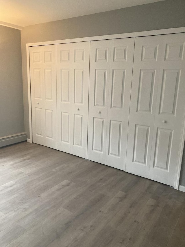 6300 N Sheridan Rd Unit 517, Chicago, IL 60660 - unfurnished bedroom featuring a closet and dark wood finished floors