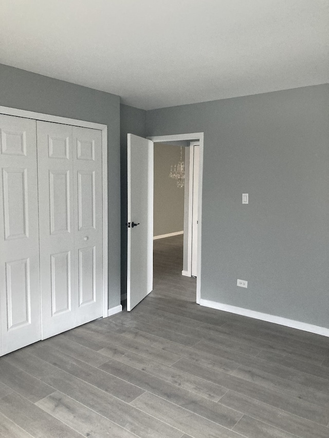 6300 N Sheridan Rd Unit 517, Chicago, IL 60660 - unfurnished bedroom with a chandelier, a closet, and wood finished floors