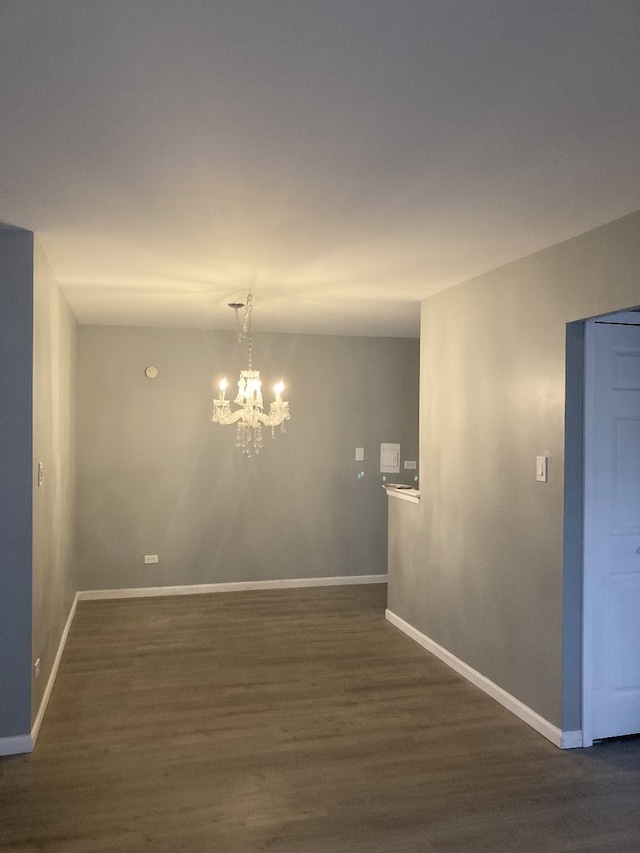 6300 N Sheridan Rd Unit 517, Chicago, IL 60660 - empty room with dark wood finished floors and a chandelier