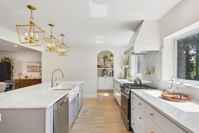 0N467 Cloos Ct, Winfield, IL 60190 - kitchen with stainless steel appliances, extractor fan, light wood finished floors, arched walkways, and pendant lighting