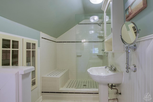 275 N Main St, Crystal Lake, IL 60014 - bathroom featuring a shower stall, vaulted ceiling, and a wainscoted wall