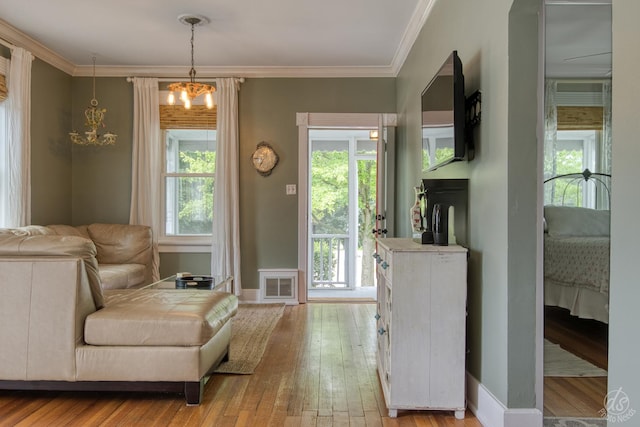 275 N Main St, Crystal Lake, IL 60014 - living area featuring a chandelier, wood-type flooring, plenty of natural light, and ornamental molding