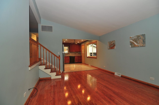 1033 S Main Dr, Lombard, IL 60148 - unfurnished living room featuring light wood-style flooring, stairs, vaulted ceiling, and a ceiling fan