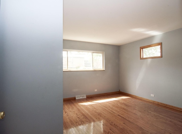 1033 S Main Dr, Lombard, IL 60148 - spare room with plenty of natural light and wood finished floors