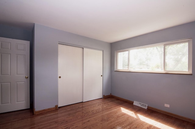 1033 S Main Dr, Lombard, IL 60148 - unfurnished bedroom featuring a closet and wood finished floors